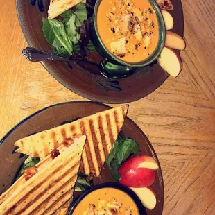 two plates of soup and a grilled cheese sandwich
