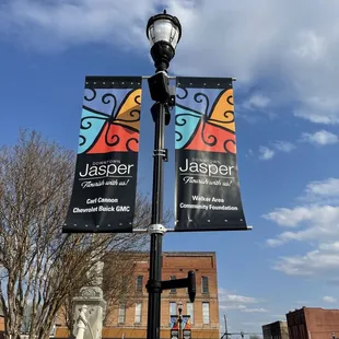 a street light with banners on it