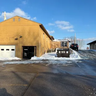 a yellow building with two garages