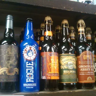 a variety of beer bottles on a shelf