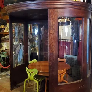 a round table and green chairs