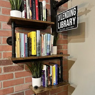 a shelf with books and plants