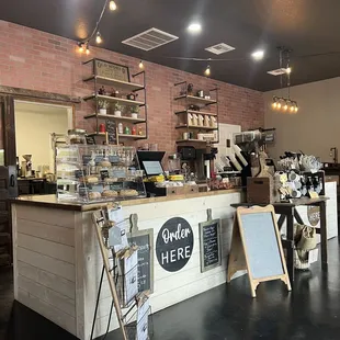 a coffee shop with a brick wall