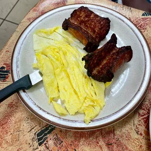 a plate of scrambled eggs and bacon