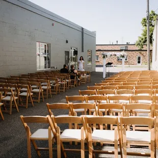 rows of wooden chairs lined up outside