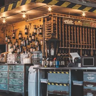 a bar with a lot of bottles on the wall