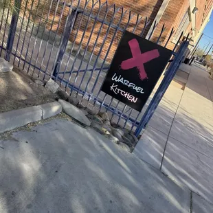 Walk around gate to enter