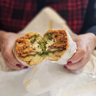 a person holding a sandwich