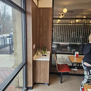 a woman sitting at a table in a restaurant