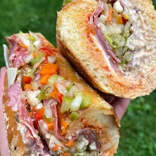 a hand holding a sandwich