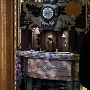 a man standing in front of a clock