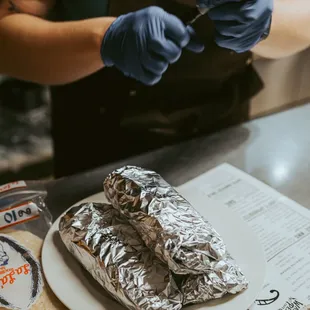 a person preparing a burrito
