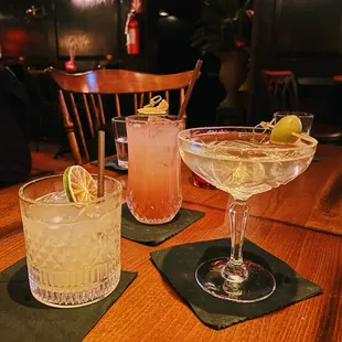 three cocktails on a wooden table