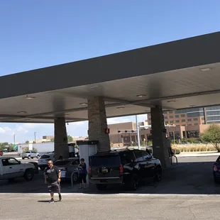 a gas station with several cars parked in front of it