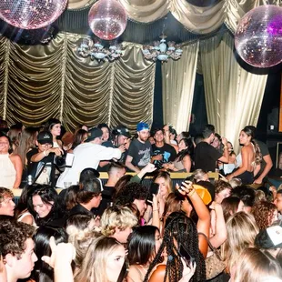 a crowd of people dancing in a club