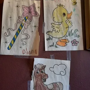 drawings of children&apos;s drawings on a refrigerator