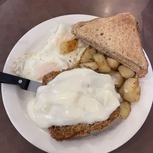 Country Fried Steak with Over Easy Eggs; Hasbrowns and Wheat Toast.