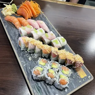 Yellow tail sushi , salmon sashimi, out of control roll, green river roll and Alaska roll.