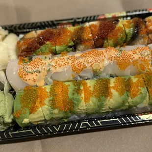 three sushi rolls on a plate