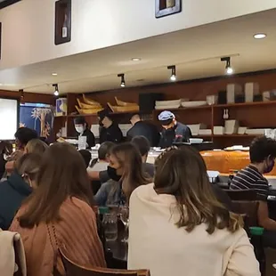 a group of people sitting at tables in a restaurant
