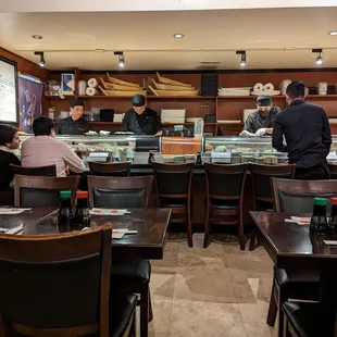 a group of people at a sushi restaurant