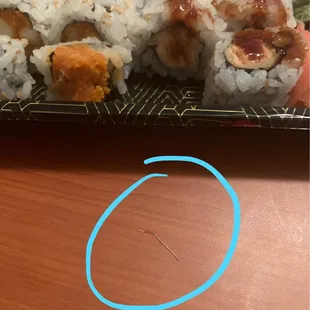 The fish bone found in my sushi (maybe 2-3cm). It was in the middle of the salmon roll I ordered.