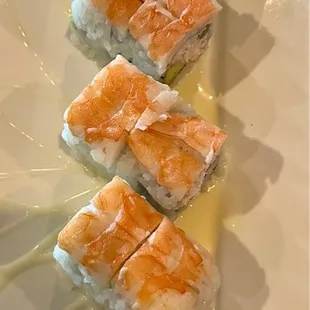 a plate of sushi with sauce