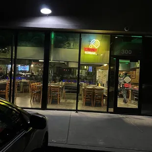 the outside of a restaurant at night