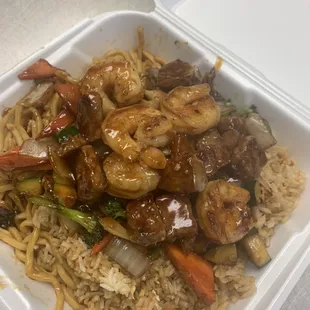 Shrimp and NY strip steak with rice and noodles dinner.