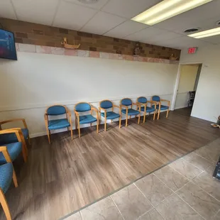 a waiting area with chairs and a television