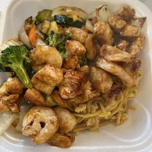 Chicken and shrimp hibachi dinner with vegetables and noodle