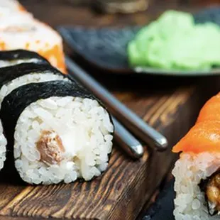 a variety of sushi on a cutting board