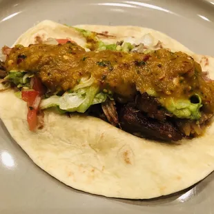 Carnitas taco with spicy tomatillos salsa!