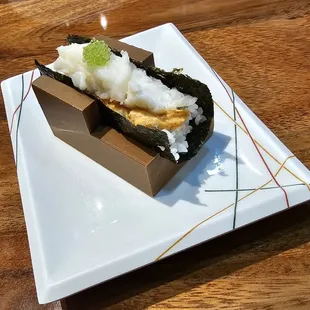a sushi on a square plate