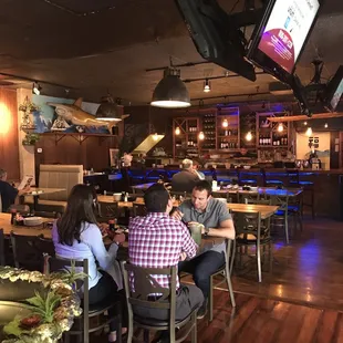 people sitting at tables in a restaurant