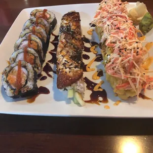 a plate of sushi and rolls