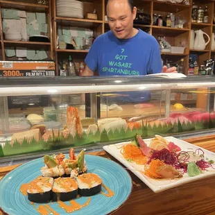 a man behind a sushi counter