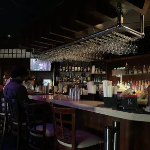 a bar with people sitting at it