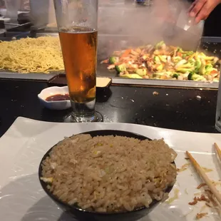 Fried rice. Noodles and veggies in the background