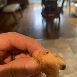 a hand holding a piece of food
