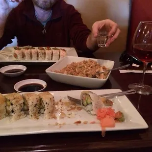 a man eating sushi at a restaurant