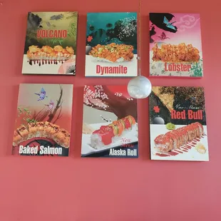 a pink wall with posters on it