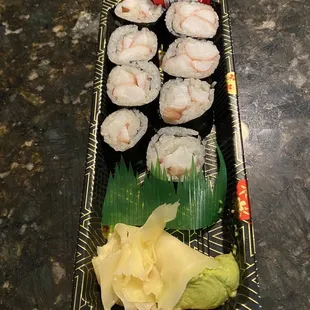 a plate of sushi and rolls