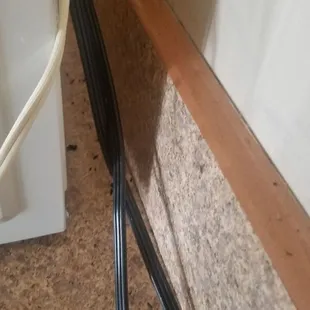 Another photo behind microwave showing poop