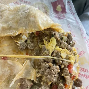 Steak breakfast Burrito with big clumps of egg shell