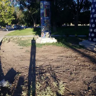 My shadow is loving the art totems at Washington Middle School Park...