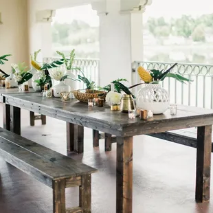 Farm tables with tropical florals at the boathouse. (Photo by Decorus Photography.)