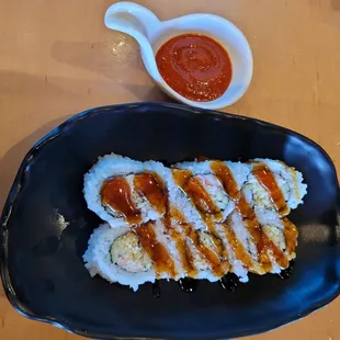 a plate of sushi and sauce
