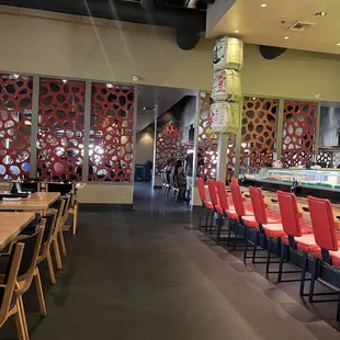 Orange decor of main dining area. Teppanyaki dining area to the back, sushi bar on the right