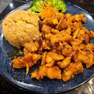 Orange chicken with fried rice and vegetables.